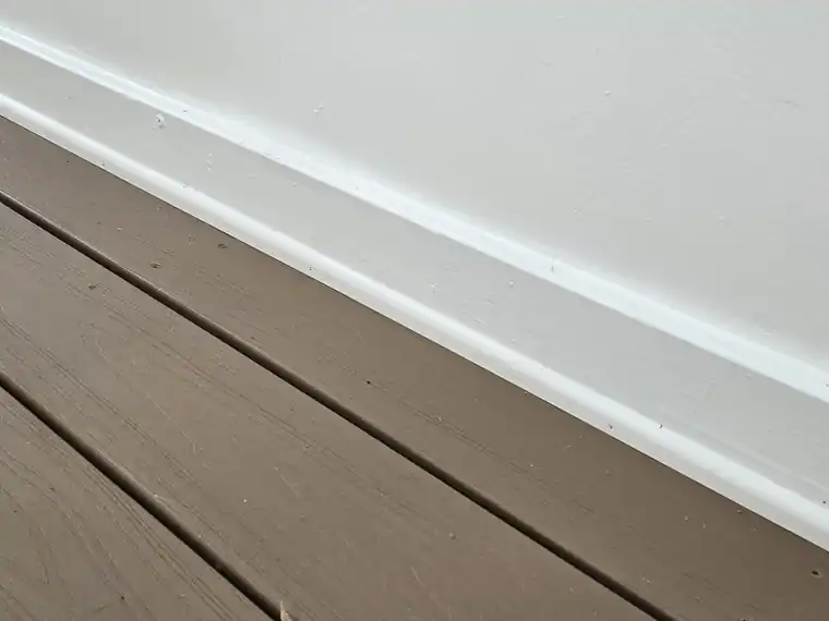 Fresh white baseboard installed along a wall