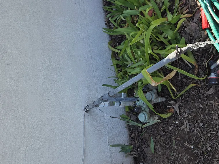 Sprinkler valve manifold and supply line repaired at a garden bed